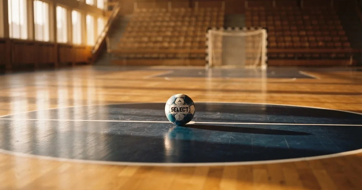 A ball on the centre spot of a grass pitch in morning light